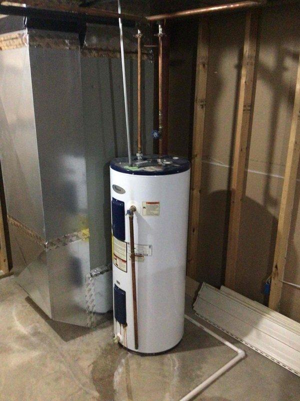 Installed a 50-gallon electric short water heater in unfinished basement utility area with COD payment arrangement. Unit was positioned adjacent to existing HVAC equipment with copper supply lines connected to home's plumbing system and proper electrical connections made to heating elements and thermostat controls.