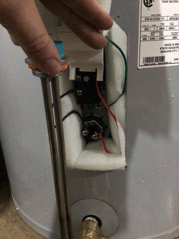 Installed a 50-gallon electric short water heater in unfinished basement utility area with COD payment arrangement. Unit was positioned adjacent to existing HVAC equipment with copper supply lines connected to home's plumbing system and proper electrical connections made to heating elements and thermostat controls.