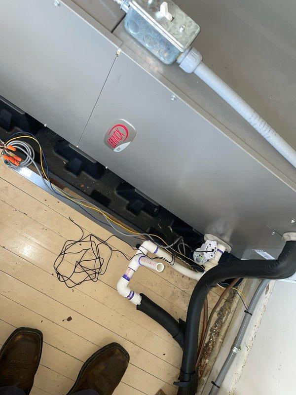 Responded to no-cool call on 5-year-old Lennox air handler unit. Upon arrival, found unit completely non-responsive with no power to system. Performed diagnostic testing at wall-mounted control panel and thermostat. Customer had already attempted battery replacement in thermostat without resolution, as documented on-site. Removed air handler access panel to inspect internal components and wiring connections. Traced power supply through control board, transformer, and wiring harness. Identified failed control board as root cause of system failure. Replaced defective Emerson control module and verified proper voltage at all connection points. Tested all safety circuits and confirmed proper condensate drain operation through transparent drain line section. Restored power to unit and cycled system through complete startup sequence. Verified proper communication between thermostat and air handler, confirmed all indicator lights functioning correctly, and ensured unit responded appropriately