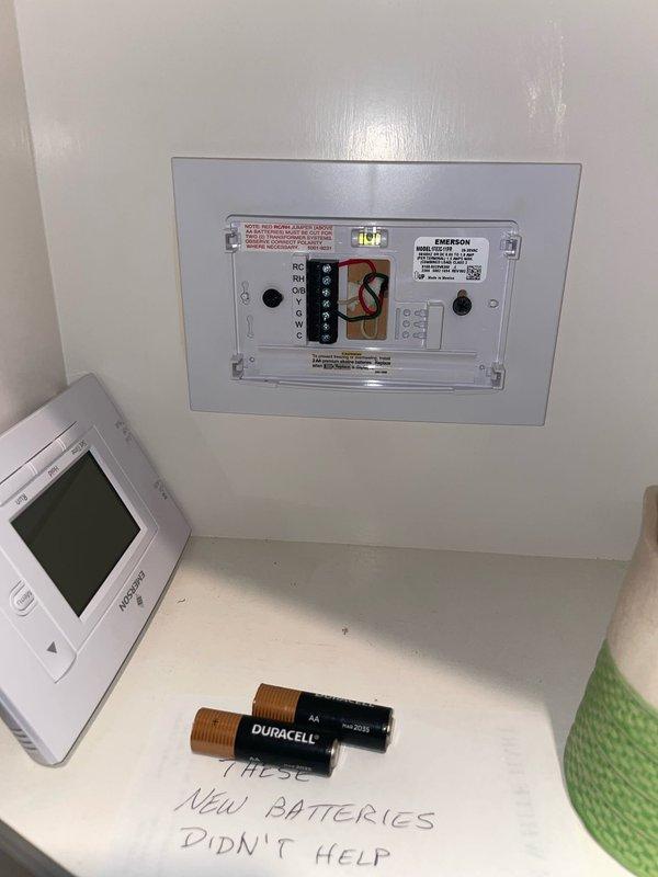 Responded to no-cool call on 5-year-old Lennox air handler unit. Upon arrival, found unit completely non-responsive with no power to system. Performed diagnostic testing at wall-mounted control panel and thermostat. Customer had already attempted battery replacement in thermostat without resolution, as documented on-site. Removed air handler access panel to inspect internal components and wiring connections. Traced power supply through control board, transformer, and wiring harness. Identified failed control board as root cause of system failure. Replaced defective Emerson control module and verified proper voltage at all connection points. Tested all safety circuits and confirmed proper condensate drain operation through transparent drain line section. Restored power to unit and cycled system through complete startup sequence. Verified proper communication between thermostat and air handler, confirmed all indicator lights functioning correctly, and ensured unit responded appropriately