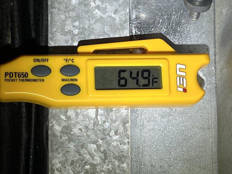 Responded to no cooling complaint on 10+ year old geothermal system located on second floor. Upon arrival, found return air filter heavily restricted with debris, causing reduced airflow and inadequate cooling performance. Measured supply air temperature at 64.9°F, confirming insufficient cooling output. Replaced dirty air filter with new pleated filter, restoring proper airflow to system. System operational and cooling properly upon departure.