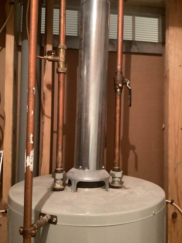 Replaced leaking 40-gallon gas water heater with new tall tank unit due to failure at drain spigot and suspected internal tank leaks. Completed full installation including copper piping connections, pressure relief valve, shut-off valves, and metallic flue pipe venting system in accordance with permit #26plu-11425. Applied required plumbing identification sticker to completed installation.