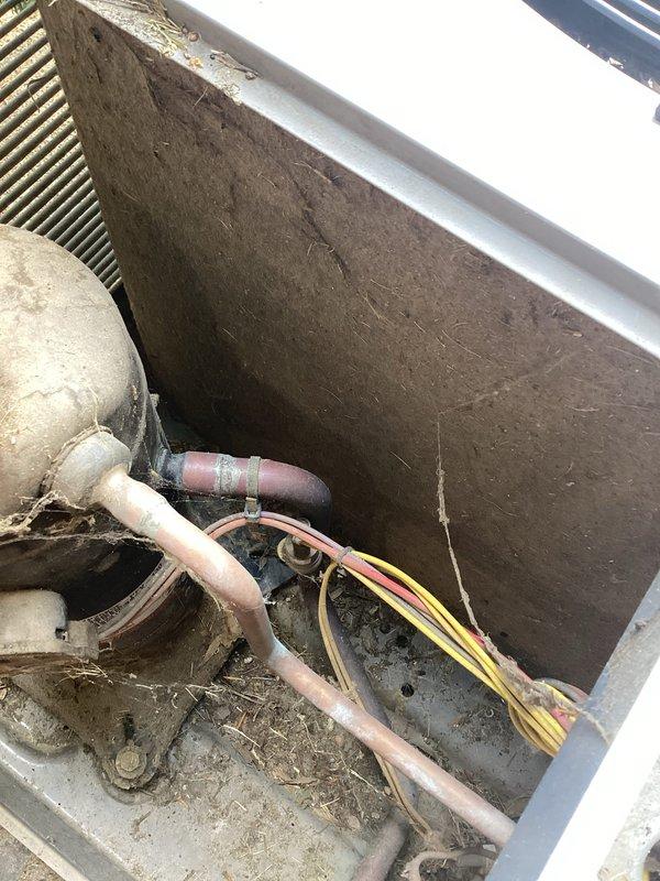 Responded to no cooling complaint with indoor temperature at 81°F and system running continuously. Upon inspection, found outdoor condensing unit with heavily weathered copper refrigerant lines and aged electrical connections showing significant environmental exposure. Performed diagnostic evaluation of outdoor unit components, inspected condenser coil fins through louver grille, and assessed overall system condition. Unit displayed substantial dirt and debris accumulation on both internal and external components. Documented equipment condition with photographs showing corroded piping, aged wiring, and compromised connections at outdoor unit. Completed system assessment for elderly residents requiring immediate cooling restoration.