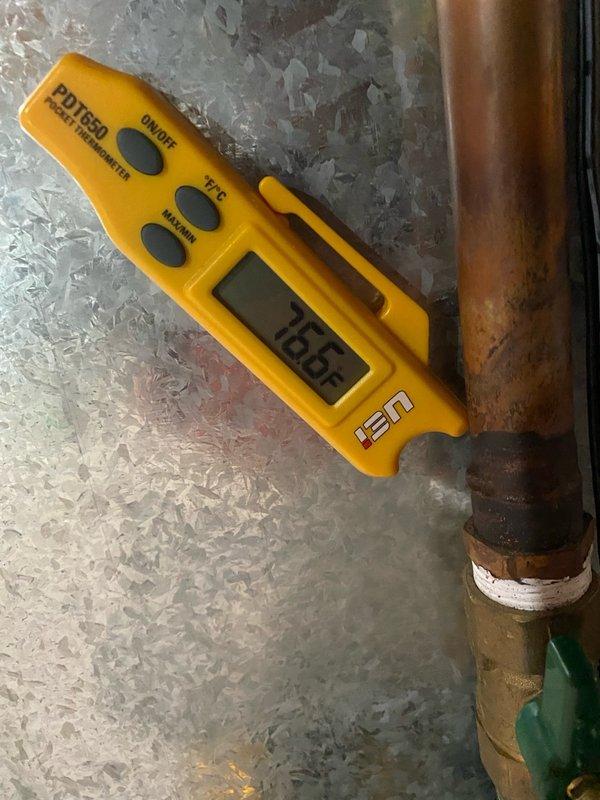 Completed comprehensive air conditioning tune-up on single residential unit located in basement with raised installation. Performed standard maintenance procedures including temperature verification, recording 76.6°F supply air temperature, and inspected refrigerant lines showing normal copper oxidation with proper insulation. Replaced dirty air filter with visible dust accumulation to restore proper airflow and system efficiency.