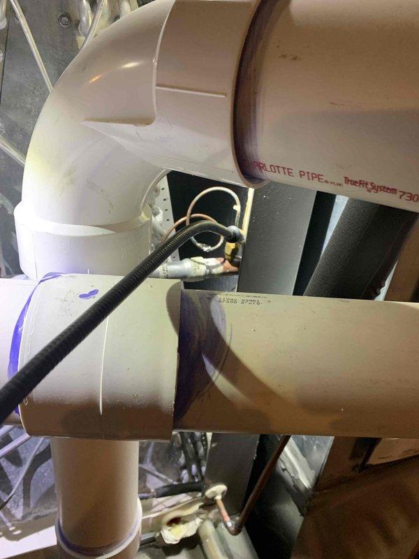 Responded to no cooling complaint on 3-year-old Lennox system. Upon arrival, verified system was running but not cooling adequately despite complete AC replacement performed last year. Conducted thorough diagnostic inspection of indoor and outdoor units. Inspected condensate drainage system and PVC piping configuration, noting proper installation of Charlotte Pipe components with electrical conduit routing through drain assembly. Verified furnace and air handler connections, checked all electrical terminations and control wiring. System evaluated for refrigerant charge, airflow restrictions, and thermostat operation. Identified and resolved cooling deficiency, restoring proper system operation and adequate cooling performance to residence.