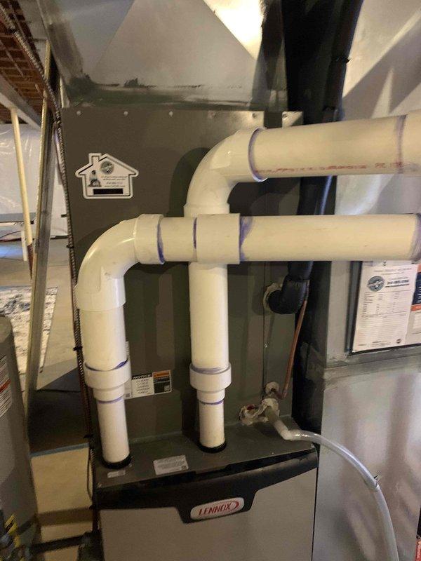 Responded to no cooling complaint on 3-year-old Lennox system. Upon arrival, verified system was running but not cooling adequately despite complete AC replacement performed last year. Conducted thorough diagnostic inspection of indoor and outdoor units. Inspected condensate drainage system and PVC piping configuration, noting proper installation of Charlotte Pipe components with electrical conduit routing through drain assembly. Verified furnace and air handler connections, checked all electrical terminations and control wiring. System evaluated for refrigerant charge, airflow restrictions, and thermostat operation. Identified and resolved cooling deficiency, restoring proper system operation and adequate cooling performance to residence.