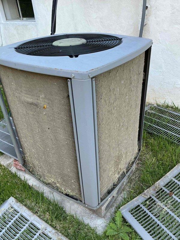 Performed comprehensive tune-up maintenance on outdoor condensing unit with unit number F58697093. Condenser coils exhibited significant accumulation of dirt, dust, and debris on exterior panels and fins, requiring thorough cleaning to restore proper airflow and heat transfer efficiency. Cleaned evaporator coil assembly, which showed multiple horizontal fin rows in satisfactory condition with minor discoloration. System operational following maintenance procedures.