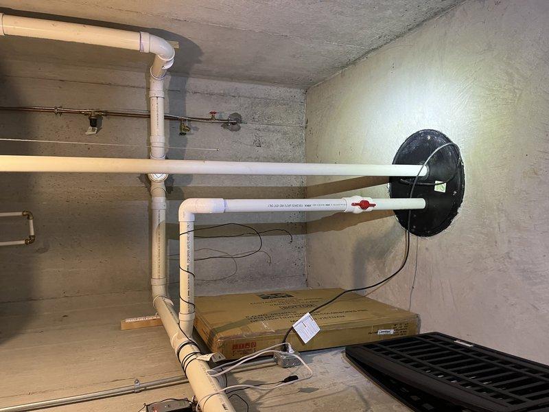 Responded to no cool call on ground-mounted unit U10 experiencing water leakage and drainage issues. Upon inspection, found severely corroded condensate drain components with heavy rust buildup on floor flange and drain fitting, causing water to back up and leak around the unit rather than draining properly. The corroded drain system was preventing proper condensate removal, which contributed to the cooling performance complaint. Documented existing conditions with photos showing extensive corrosion on drain hardware and water staining on concrete floor around drain assembly.