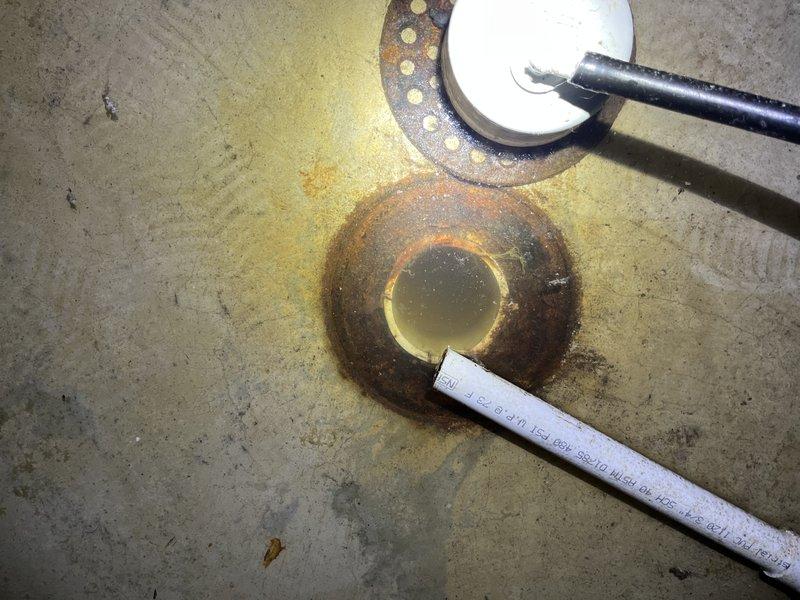 Responded to no cool call on ground-mounted unit U10 experiencing water leakage and drainage issues. Upon inspection, found severely corroded condensate drain components with heavy rust buildup on floor flange and drain fitting, causing water to back up and leak around the unit rather than draining properly. The corroded drain system was preventing proper condensate removal, which contributed to the cooling performance complaint. Documented existing conditions with photos showing extensive corrosion on drain hardware and water staining on concrete floor around drain assembly.