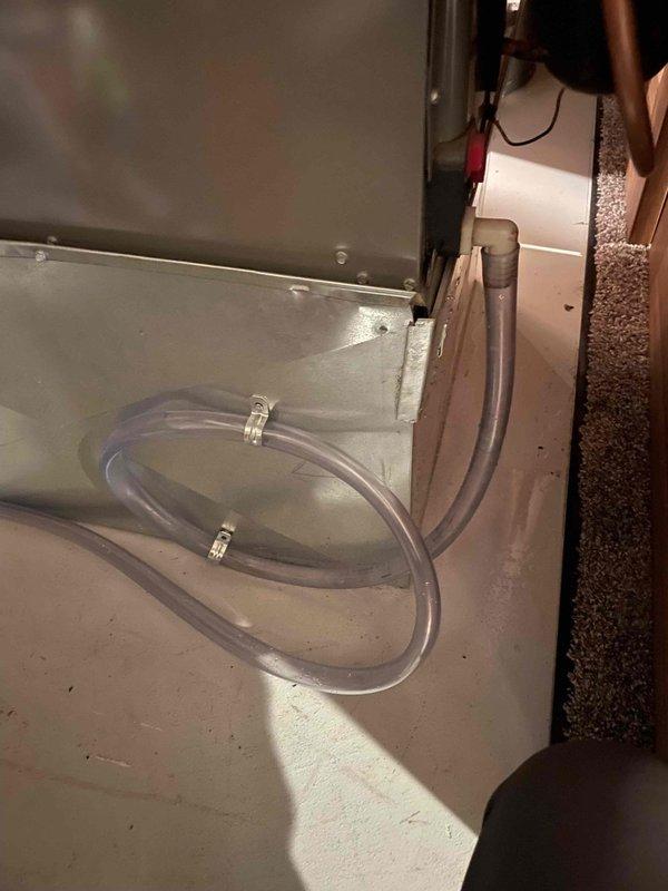 Responded to water leak issue affecting indoor air handler unit. Upon inspection, found condensate drainage line improperly routed, causing water to drain onto the return air filter. Cleared existing blockage from drain line, repositioned and secured drainage tubing with proper clips to ensure gravity flow to designated drain point. Verified condensate pump operation and confirmed no water accumulation in drain pan. System tested and operating without leaks.
