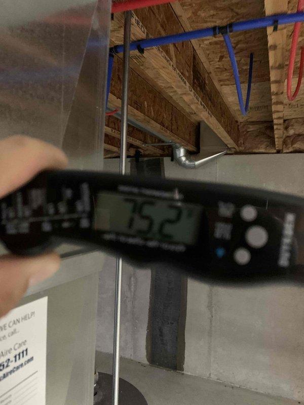 Responded to second opinion request for AC unit with reported 11-degree temperature differential on return air. Performed diagnostic evaluation on 10+ year old outdoor unit located at side of home. Measured and verified system temperatures using digital instrumentation at return air location in crawlspace area. Inspected thermostat operation showing 73°F room temperature setting with system controls in proper position. Documented findings with diagnostic measurements and system component photos for home sale inspection requirements.