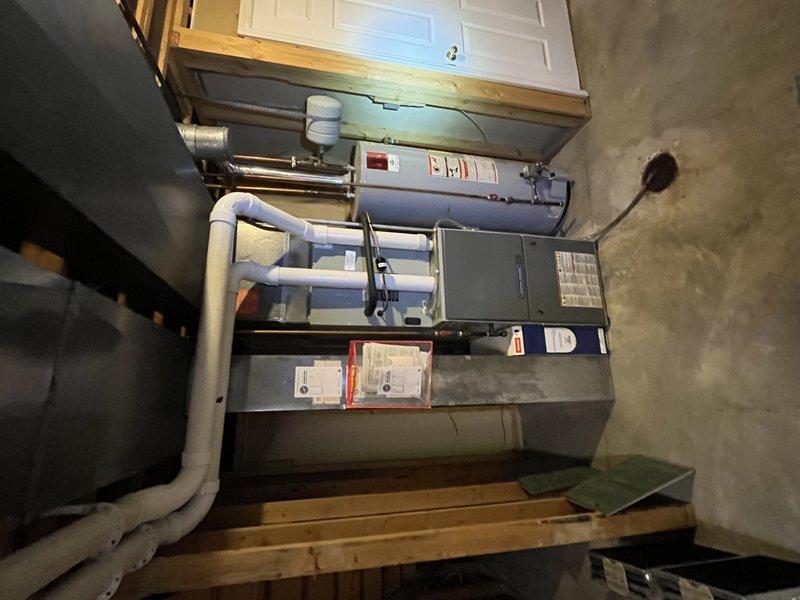 Responded to cooling efficiency complaint affecting main level while lower level maintained adequate temperatures. Upon inspection, identified compromised condensate drainage system causing water backup and abnormal operational sounds. Cleared blocked condensate line, verified proper drainage flow through PVC piping system, and inspected air handler components including circuit board connections and electrical systems for proper operation. Addressed water discharge issue that was bypassing condensate hose during shutdown cycles. System tested and confirmed restored cooling capacity to all zones with proper condensate removal functioning as designed.