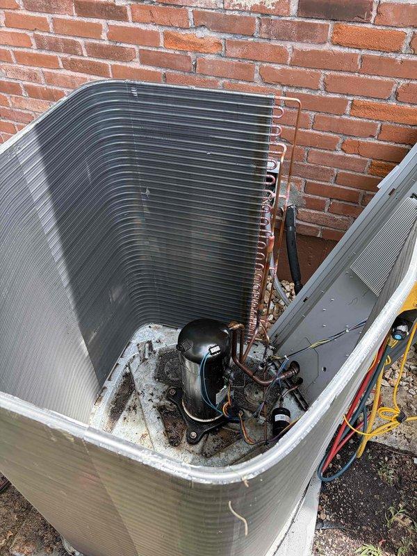 Replaced failed condenser coil on residential outdoor air conditioning unit. Removed top cover to access internal components, disconnected refrigerant lines from compressor, and extracted old condenser coil assembly. Installed new condenser coil with proper refrigerant line connections to compressor. Disposed of defective coil per standard procedures. Unit restored to operational condition.
