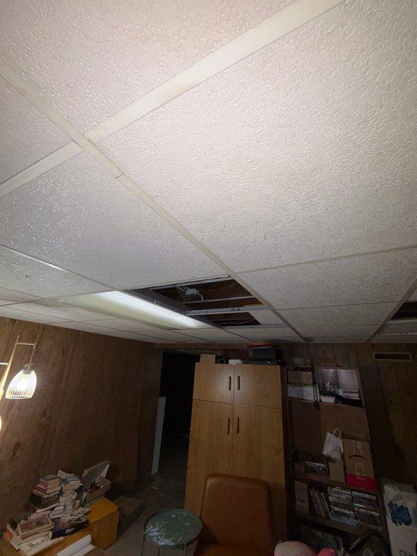 Returned to property to reevaluate electrical estimate originally prepared in November. Conducted thorough visual inspection of residential interior spaces, including hallway area with visible ceiling discoloration and basement storage room with drop ceiling system. Documented current conditions through photography for updated assessment purposes. No electrical work performed during this visit.