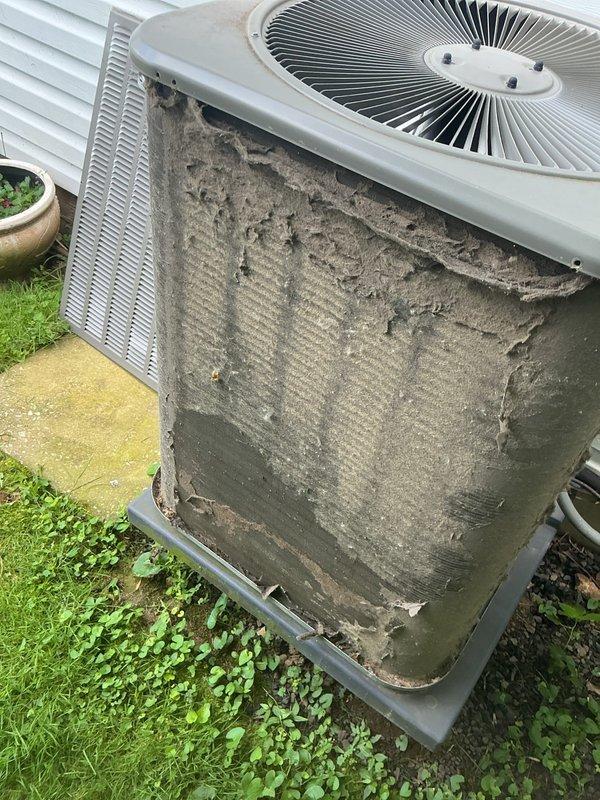 Responded to emergency service call for 10-year-old air conditioning system producing metal clunking sounds. Upon inspection, found outdoor condenser unit with severely clogged condenser coil covered in thick layers of dirt, dust, and debris accumulation, significantly restricting airflow and causing system strain. Performed thorough cleaning of condenser coil fins to restore proper airflow and heat transfer efficiency. Inspected fan motor and blades for source of clunking noise, verified fan operation and blade clearances. Checked refrigerant levels, electrical connections, and capacitor function. System restored to normal operation with improved airflow and no abnormal sounds detected during test run.