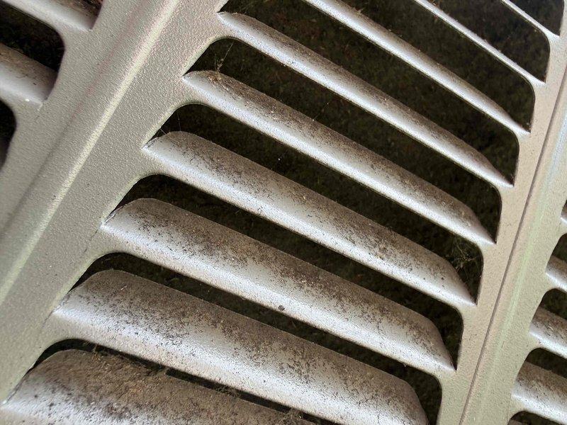 Responded to no cooling complaint on residential HVAC system with history of low refrigerant charge from previous season. Upon arrival, found outdoor condenser unit surrounded by vegetation and indoor return air grille heavily soiled with dust and debris accumulation. Performed system diagnostics to determine cause of inadequate cooling performance. Inspected refrigerant levels, electrical connections, and airflow components. Return air restriction from dirty grille was impeding proper system operation and reducing cooling capacity. Cleaned return air grille and addressed airflow issues to restore proper system function and temperature maintenance capability.