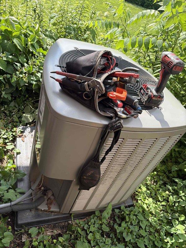 Responded to no cooling complaint on residential HVAC system with history of low refrigerant charge from previous season. Upon arrival, found outdoor condenser unit surrounded by vegetation and indoor return air grille heavily soiled with dust and debris accumulation. Performed system diagnostics to determine cause of inadequate cooling performance. Inspected refrigerant levels, electrical connections, and airflow components. Return air restriction from dirty grille was impeding proper system operation and reducing cooling capacity. Cleaned return air grille and addressed airflow issues to restore proper system function and temperature maintenance capability.