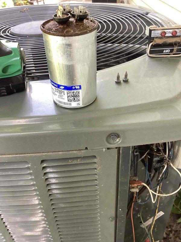 Responded to no cooling complaint on residential air conditioning system. Upon inspection, found failed dual run capacitor with visible corrosion and discoloration on terminal connections. Replaced defective capacitor with new unit, restored system to proper operation, and verified cooling performance. Unit tested and left operational.