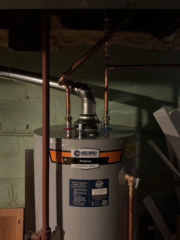 Installed a 50-gallon tall gas water heater (State ProLine model) in basement utility area. Connected copper supply lines with hot and cold shut-off valves, installed temperature and pressure relief valve, and completed all necessary plumbing connections per code requirements. Applied plumbing identification sticker and obtained permit 26PLU-11538 for installation compliance.