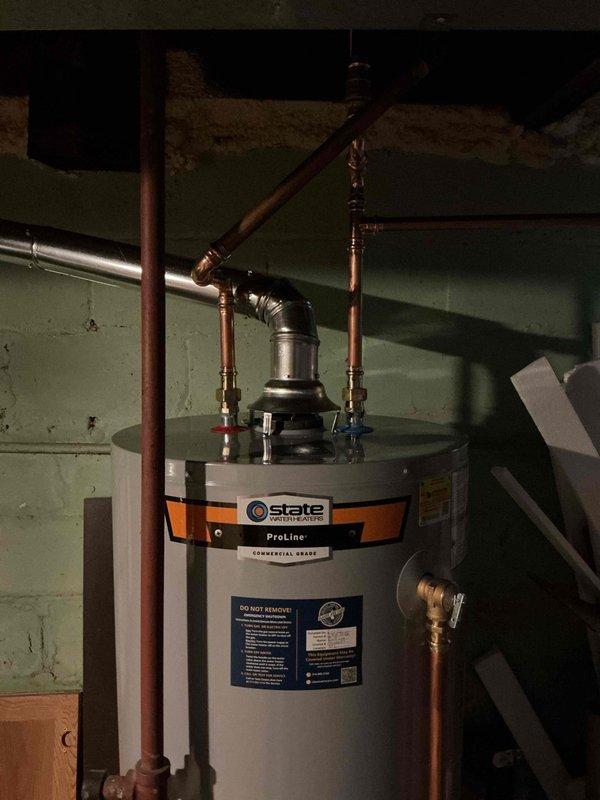 Installed a 50-gallon tall gas water heater (State ProLine model) in basement utility area. Connected copper supply lines with hot and cold shut-off valves, installed temperature and pressure relief valve, and completed all necessary plumbing connections per code requirements. Applied plumbing identification sticker and obtained permit 26PLU-11538 for installation compliance.