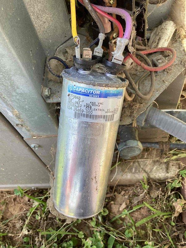 Responded to no cooling complaint affecting entire residence. Upon arrival, performed system diagnostics and identified failed dual run capacitor as primary cause of system failure. Capacitor exhibited severe corrosion and rust on mounting housing, indicating extended exposure to moisture and age-related deterioration. Component showed visible oxidation on metal surfaces and mounting points, compromising electrical connections and system performance. Removed defective capacitor and replaced with new unit to manufacturer specifications. Verified proper wire connections, tested system operation, and confirmed cooling restored to all zones. Unit returned to normal operating parameters with adequate airflow and temperature differential across evaporator coil.