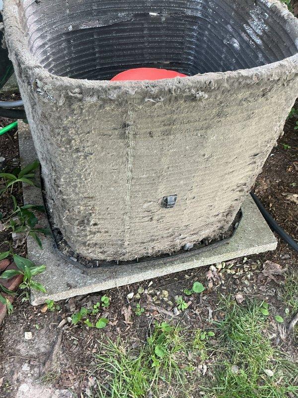 Responded to no cooling complaint on 10+ year old outdoor condenser unit located in backyard. Upon arrival, found unit operational but with severely restricted airflow due to heavy accumulation of dirt, dust, and debris coating exterior surfaces and condenser coils. Observed frost buildup on evaporator coil, indicating restricted airflow and reduced heat transfer efficiency. Documented existing conditions with photographs showing deteriorated exterior casing and contaminated coil surfaces. Diagnosed primary issue as inadequate system maintenance resulting in diminished cooling capacity and potential refrigerant circuit complications from extended operation under restricted conditions.