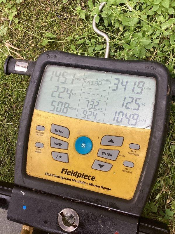 Responded to no cooling complaint on outdoor condensing unit located at rear of property. Upon arrival, connected manifold gauges to service ports and recorded system pressures and temperatures. R-410A refrigerant system showed abnormal operating pressures with high-side reading of 224 PSI and temperature differential indicating potential airflow restriction. Removed access panel and inspected condenser coil assembly, which revealed moderate accumulation of dirt and debris between aluminum fins. Condenser coil showed signs of reduced heat transfer efficiency due to contamination buildup. Copper refrigerant lines displayed normal age-related oxidation with no visible leaks detected. System components appeared structurally sound with no immediate mechanical failures observed. Documented equipment condition with diagnostic photos for service records.