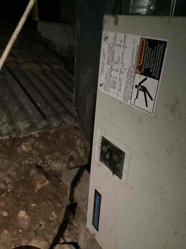 Responded to no cooling complaint on 27-year-old residential air conditioning system. Upon arrival, performed diagnostic assessment of indoor air handler located in crawlspace and outdoor condensing unit at ground level. Conducted visual inspection of equipment, checked electrical connections, and evaluated system components for proper operation. Documented equipment condition with photographs showing air handler installation and crawlspace environment. System required comprehensive evaluation due to age and reported performance issues.