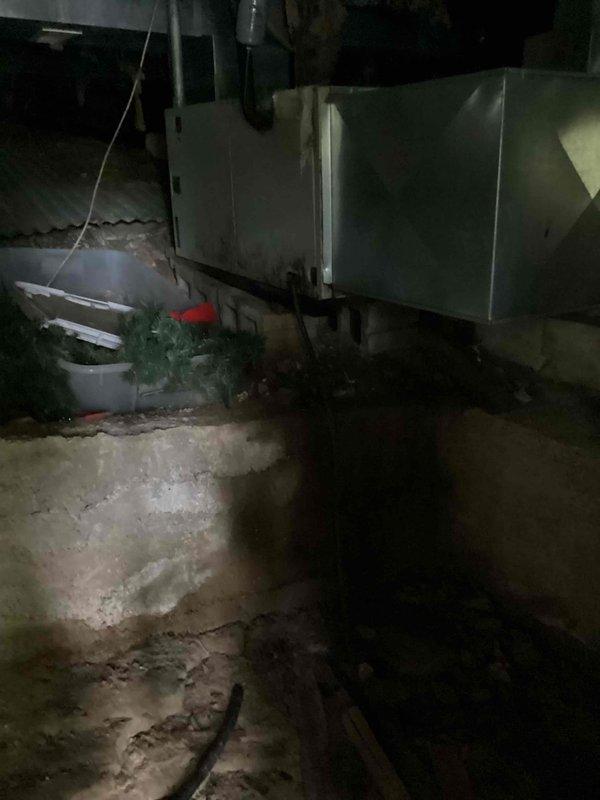 Responded to no cooling complaint on 27-year-old residential air conditioning system. Upon arrival, performed diagnostic assessment of indoor air handler located in crawlspace and outdoor condensing unit at ground level. Conducted visual inspection of equipment, checked electrical connections, and evaluated system components for proper operation. Documented equipment condition with photographs showing air handler installation and crawlspace environment. System required comprehensive evaluation due to age and reported performance issues.