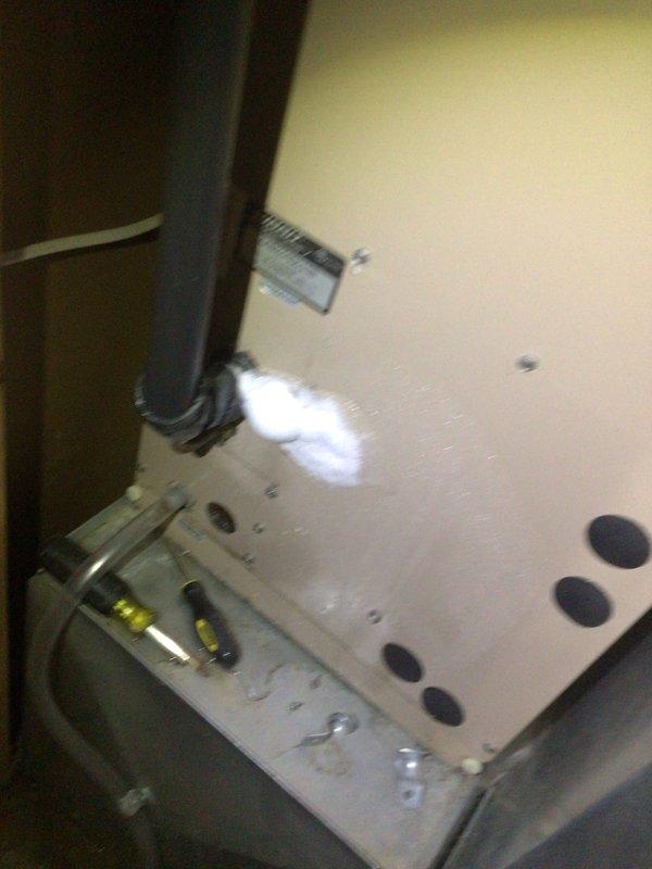 Responded to service call for frozen AC line on 10-year-old outdoor unit located at back of condo. Upon inspection, found severely restricted airflow due to heavily soiled air filter with significant dust and debris accumulation. Removed and replaced dirty filter, which was causing reduced system airflow and subsequent evaporator coil freeze-up. Inspected interior cabinet components and ductwork connections for proper operation. System allowed to thaw completely before restart. Verified proper airflow restoration and normal operating temperatures upon completion.