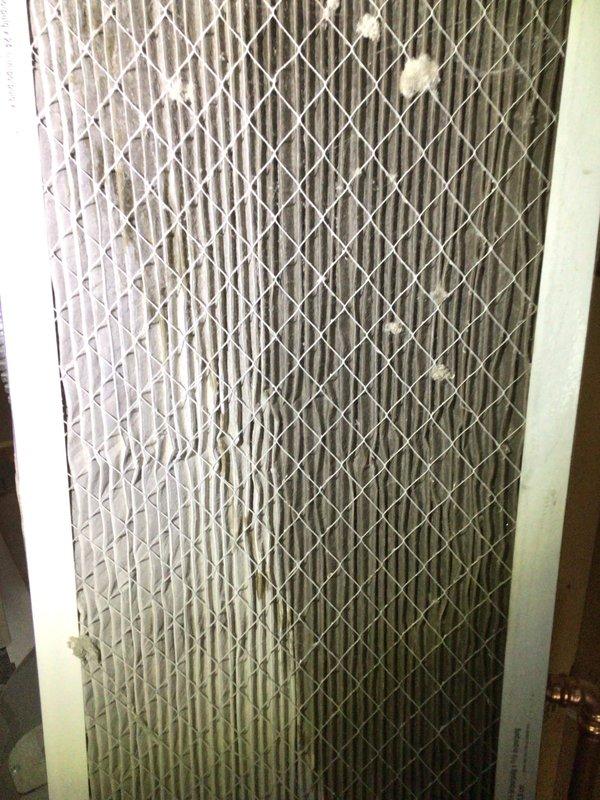 Responded to service call for frozen AC line on 10-year-old outdoor unit located at back of condo. Upon inspection, found severely restricted airflow due to heavily soiled air filter with significant dust and debris accumulation. Removed and replaced dirty filter, which was causing reduced system airflow and subsequent evaporator coil freeze-up. Inspected interior cabinet components and ductwork connections for proper operation. System allowed to thaw completely before restart. Verified proper airflow restoration and normal operating temperatures upon completion.