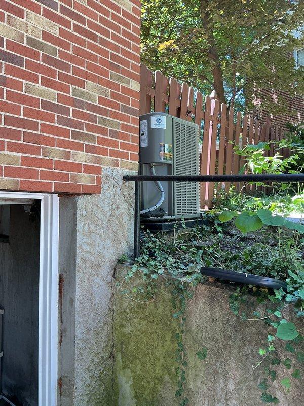 Responded to emergency service call for water leak in front of and inside furnace. Upon arrival, inspected 2021-installed furnace and Lennox air conditioning system to identify source of water intrusion. Determined leak was originating from condensate drainage issue related to outdoor AC unit, as evidenced by moisture accumulation around equipment and algae growth on foundation indicating ongoing drainage problem. Cleared condensate line blockage, verified proper drainage flow from evaporator coil, and confirmed no water penetration into furnace cabinet that could damage blower motor or control board. Tested system operation to ensure proper function and no further water accumulation.