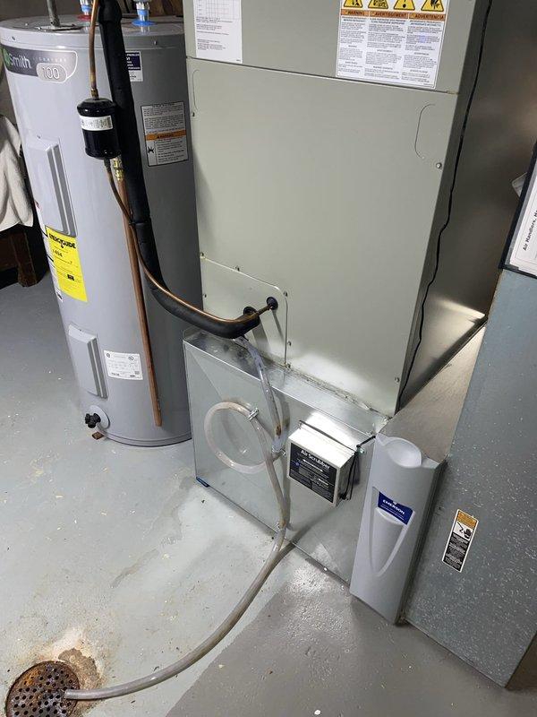 Responded to no-cool call and water leak complaint on 2-4 year old Emerson air handler. Upon inspection, found condensate drain system improperly draining, with water bypassing the attached drain hose and leaking from corner of drain pan. Inspected drain pan for cracks and blockages, cleared primary condensate line, and verified proper drainage flow through attached hose. Tested unit operation and confirmed condensate now draining correctly through designated drain line with no further leakage from pan corners.