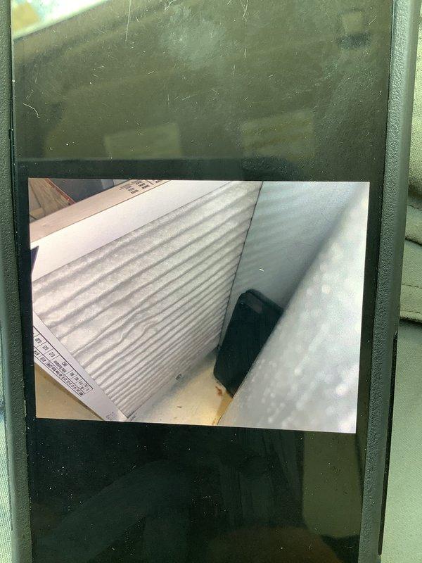 Responded to customer complaint of upstairs AC unit running continuously without adequate cooling. Performed diagnostic evaluation on 9-year-old residential air conditioning system. Inspected outdoor condenser unit, noting dirt and debris accumulation on coil fins affecting heat transfer efficiency. Examined indoor air handler components including filter housing and ductwork. Documented system condition with photographic evidence showing weathered condenser coils with visible contamination and standard filter installation. System assessed for potential airflow restrictions and refrigerant performance issues common in units of this age and condition.