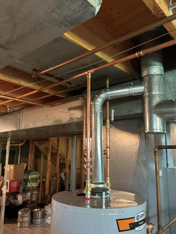 Responded to callback for failed plumbing inspection due to leaking solder joint on copper water line system. Located the defective joint in the basement mechanical area near the water heater installation. Drained down the affected line, removed the failed solder connection, cleaned and refluxed the copper pipe and fitting, and re-soldered the joint using proper technique to ensure complete penetration and watertight seal. Pressurized the system and verified no leaks were present at the repaired connection point. Inspected all other visible solder joints in the copper piping runs along the ceiling joists to confirm integrity of the installation. System tested and ready for re-inspection.