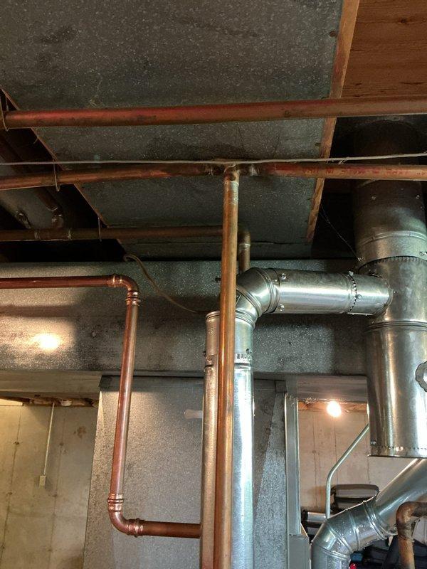 Responded to callback for failed plumbing inspection due to leaking solder joint on copper water line system. Located the defective joint in the basement mechanical area near the water heater installation. Drained down the affected line, removed the failed solder connection, cleaned and refluxed the copper pipe and fitting, and re-soldered the joint using proper technique to ensure complete penetration and watertight seal. Pressurized the system and verified no leaks were present at the repaired connection point. Inspected all other visible solder joints in the copper piping runs along the ceiling joists to confirm integrity of the installation. System tested and ready for re-inspection.