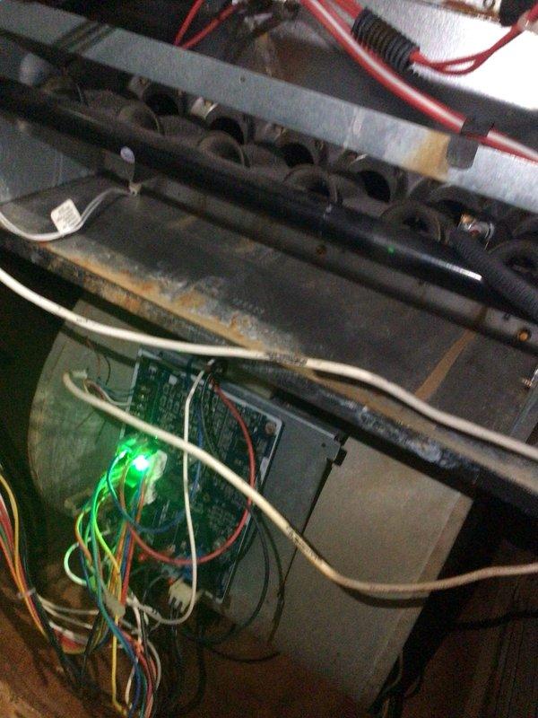 Responded to no cooling complaint on unit 10 located on side of home. Upon arrival, performed system diagnostics and inspection of both heating and cooling components. Opened unit cabinet to access internal components including heat exchanger assembly, burner tubes, and control board. Verified power supply to system with green LED indicator illuminated on circuit board. Inspected all wire connections including thermostat wiring (green, yellow, red, blue, and white) for proper termination and secure connections. Examined refrigerant line sets and condensate drainage system for proper operation. System restored to normal cooling operation.