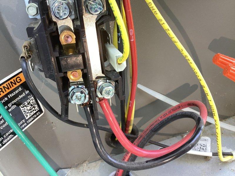 Responded to service call for AC unit making unusual noise and not cooling. Upon arrival, performed diagnostic testing on outdoor condensing unit using digital multimeter to check electrical values and verify proper voltage at terminal connections. Inspected wiring connections at terminal block and verified all electrical connections were secure and within specifications, with unit reading 53 on meter display indicating proper line voltage present at equipment.