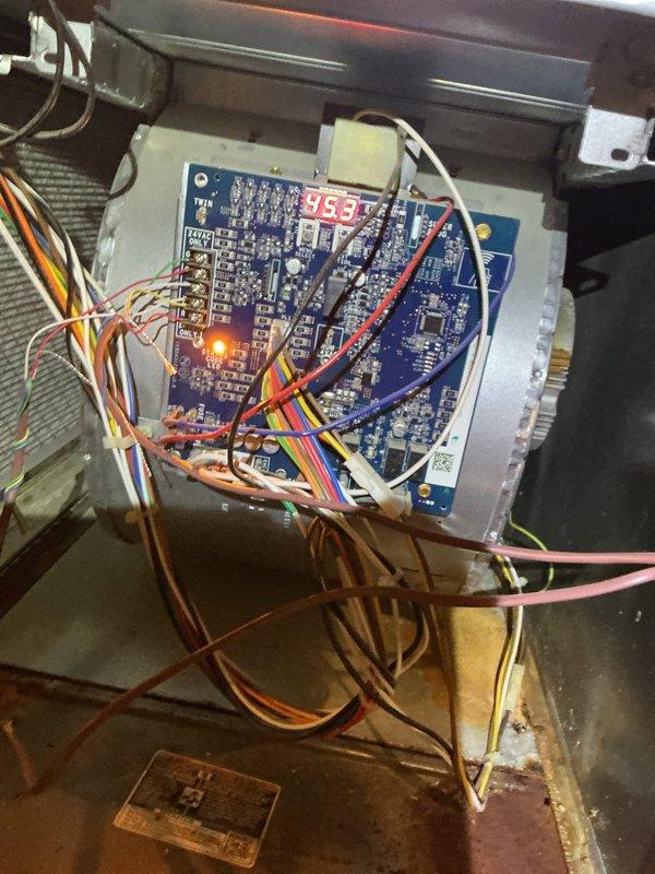 # HVAC Service Completed

Responded to Home Depot lead for residential air conditioning system experiencing surging and unusual noise following a power outage. Upon arrival, performed diagnostic inspection of the unit's electrical and control systems. Accessed the main control compartment and thoroughly examined the control boards, which displayed active power with LED readout showing 95.3. Inspected all wiring connections, including multi-conductor ribbon cables and individual circuit wires throughout the control panel. Evaluated the condition of the circuit boards for signs of power surge damage, checking for burned components, damaged resistors, or compromised circuitry. Examined all wire terminations, connectors, and junction points for loose connections, arcing, or heat damage that could result from electrical surging. Assessed the relay components and control board mounting within the metal housing. Documented the system's current operational state and electrical connections with