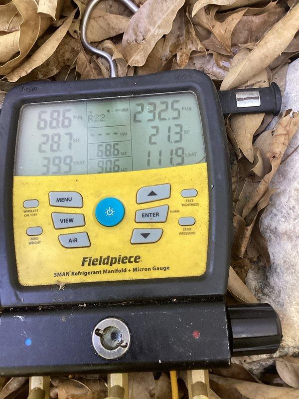 Responded to no cooling complaint on 10+ year old ground-level unit located at back of home. Upon arrival, performed diagnostic evaluation using refrigerant manifold and micron gauge to assess system pressures and operation. Inspected air filter and found restricted airflow condition. System pressures indicated 232.5 PSI high side and 21.8 PSI low side with ambient conditions present. Completed full system diagnostics and documented equipment conditions with photographic evidence for service records.