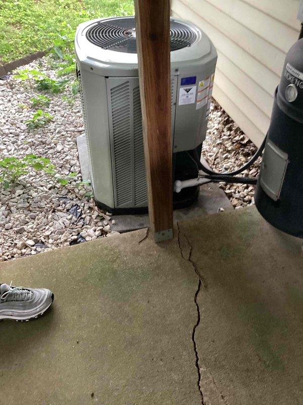Responded to service call for older residential A/C system with reported refrigerant leak causing insufficient cooling. Upon arrival, inspected outdoor condenser unit (cylindrical style, 10+ years old) located in backyard on concrete pad and indoor Janitrol High Efficiency Plus air handler unit in basement. Performed visual inspection of both components and documented equipment condition with photographs. Confirmed unit operational status and assessed refrigerant system for leak detection. Unit utilizes R-22 refrigerant (Type 3 Freon), which is phased out in newer systems. Noted system age and legacy refrigerant type require specialized service approach for repairs and future maintenance considerations.