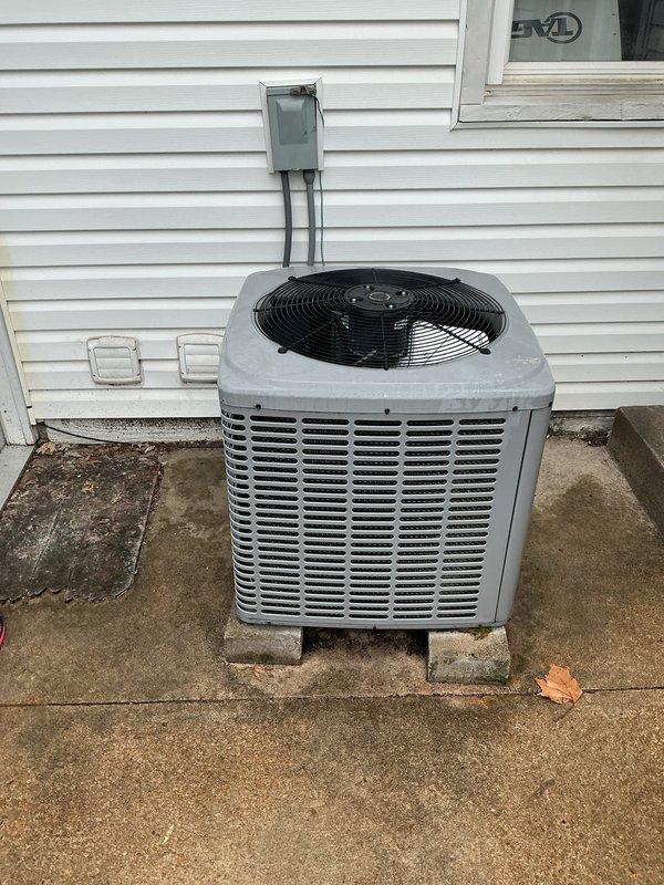 Responded to no-cool complaint on residential split system installed circa 2008. Previous contractor had replaced control board following power surge, but outdoor compressor remained non-operational. Upon arrival, confirmed outdoor condensing unit not running while indoor blower operated normally. Performed diagnostic testing on electrical components and compressor contactor. Found compressor electrically locked, likely damaged during initial power surge event when unit reportedly ran without condenser fan, causing frost formation on coils. Verified compressor windings showed abnormal resistance readings and would not start under load. Recommended compressor replacement due to internal failure from electrical damage sustained during power surge. Indoor evaporator coil showed moderate dust accumulation and drain pan exhibited biological growth and mineral deposits, requiring cleaning during future maintenance. Documented equipment condition with photographs for records.