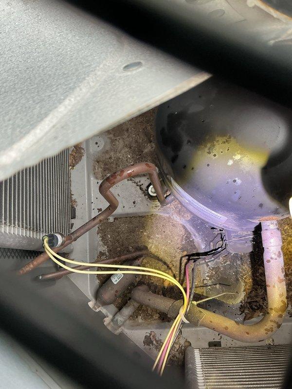 Responded to no-cool complaint on residential split system installed circa 2008. Previous contractor had replaced control board following power surge, but outdoor compressor remained non-operational. Upon arrival, confirmed outdoor condensing unit not running while indoor blower operated normally. Performed diagnostic testing on electrical components and compressor contactor. Found compressor electrically locked, likely damaged during initial power surge event when unit reportedly ran without condenser fan, causing frost formation on coils. Verified compressor windings showed abnormal resistance readings and would not start under load. Recommended compressor replacement due to internal failure from electrical damage sustained during power surge. Indoor evaporator coil showed moderate dust accumulation and drain pan exhibited biological growth and mineral deposits, requiring cleaning during future maintenance. Documented equipment condition with photographs for records.