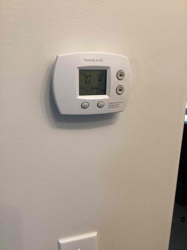 Responded to no cooling complaint on 10+ year old Lennox unit located in backyard. Upon arrival, confirmed clogged condensate drain line preventing proper system operation. Cleared drain line obstruction, verified proper drainage flow, and tested system operation. Unit cooling properly at departure with thermostat displaying appropriate temperature differential.