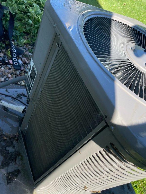 Completed preventive maintenance tune-up on a ten-year-old residential air conditioning system. Performed comprehensive inspection of outdoor condenser unit, which showed significant accumulation of dirt and debris on coil surfaces. Cleaned condenser coils, checked fan operation, verified proper airflow through grilles, and ensured unit was operating within normal parameters.