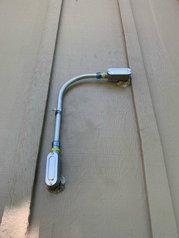 Installed dedicated electrical circuit with new wiring run from main panel to interior room location. Mounted exterior conduit with proper junction boxes and securing clamps on building exterior, then installed interior outlets with appropriate cover plates to provide power for specified equipment.