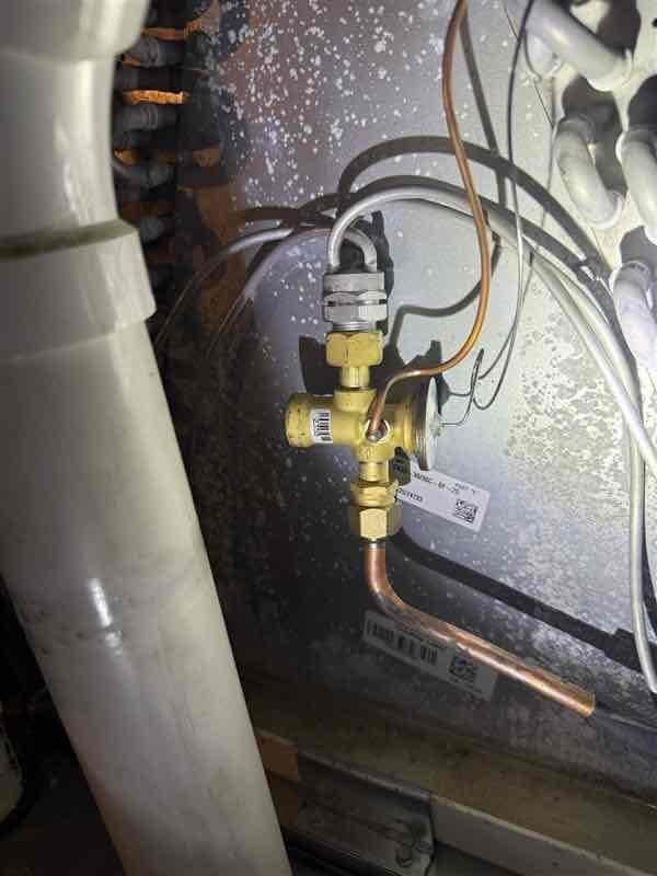 Replaced defective thermal expansion valve (TXV) on system S/N 1522G74733 to restore cooling operation. Unit was experiencing no-cool condition due to failed TXV. Recovered refrigerant, removed old valve assembly, installed new TXV with proper torque specifications on brass fittings, evacuated system, and recharged to manufacturer specifications. Verified proper system operation with temperature differential and pressures within normal range. Retained failed part per protocol.