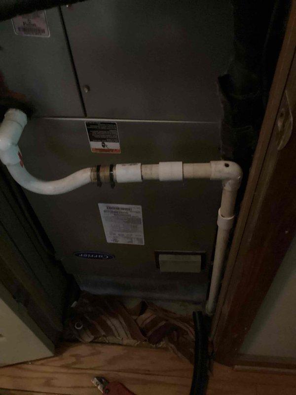 Responded to service call for reported furnace leak causing damage to flooring in utility closet. Upon arrival, inspected 10+ year old Carrier furnace unit and identified condensate drainage issue. Found PVC condensate drain lines with improper pitch and potential blockage causing water to back up and overflow onto floor. Cleared condensate drain obstruction, verified proper drainage flow, and tested system operation through complete heating cycle. Inspected secondary drain pan for cracks or damage. Checked all pipe connections and joints for leaks. Advised customer of flooring damage caused by prolonged water exposure and recommended monitoring system closely. System restored to proper operation with condensate draining correctly.