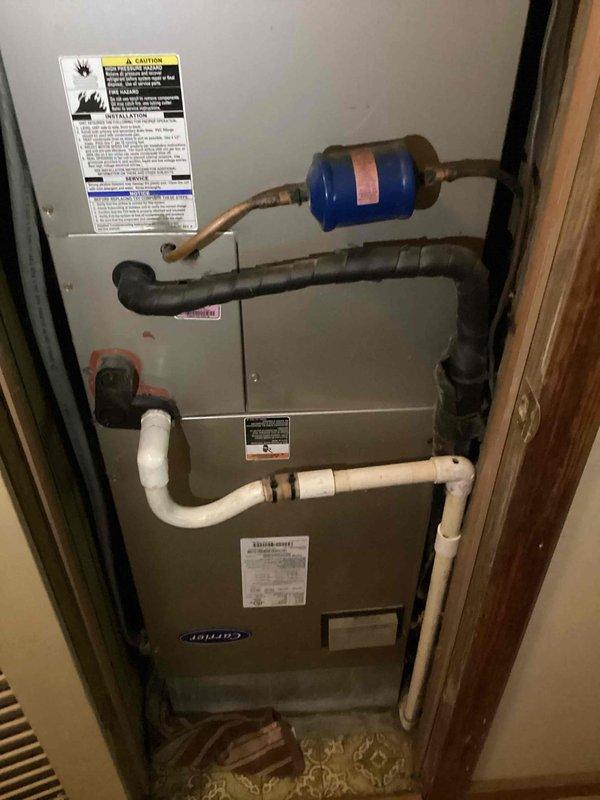 Responded to service call for reported furnace leak causing damage to flooring in utility closet. Upon arrival, inspected 10+ year old Carrier furnace unit and identified condensate drainage issue. Found PVC condensate drain lines with improper pitch and potential blockage causing water to back up and overflow onto floor. Cleared condensate drain obstruction, verified proper drainage flow, and tested system operation through complete heating cycle. Inspected secondary drain pan for cracks or damage. Checked all pipe connections and joints for leaks. Advised customer of flooring damage caused by prolonged water exposure and recommended monitoring system closely. System restored to proper operation with condensate draining correctly.
