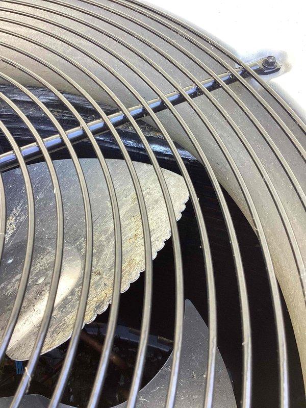 Responded to callback for AC unit running continuously. Inspected outdoor condenser unit U10 in side yard following previous cooling maintenance visit. Found fan assembly operational with protective grill intact. Observed dust and debris accumulation on fan blade and internal components affecting system efficiency. Verified unit cycling and proper airflow through condenser coil. System running as designed with no mechanical failures identified.